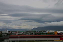 Assorted curvy clouds over Esja