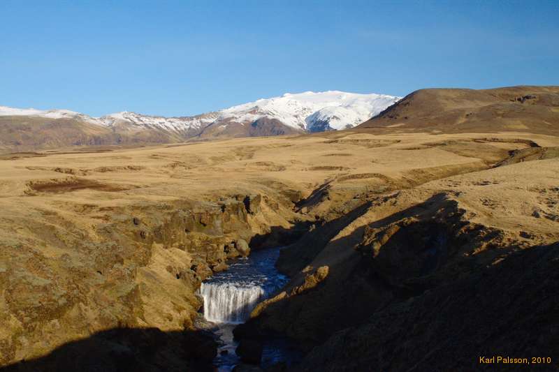 First of many waterfalls on the way up Skógá. Eyjafjallajökull in the background