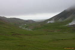 A green smokey valley, out to the sea
